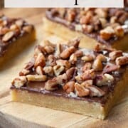chocolate toffee squares topped with nuts.
