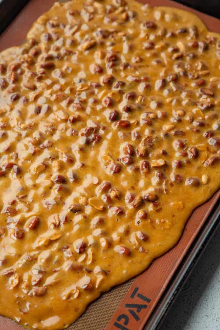 peanut brittle poured onto a baking sheet.