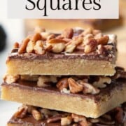 toffee squares stacked on a plate.