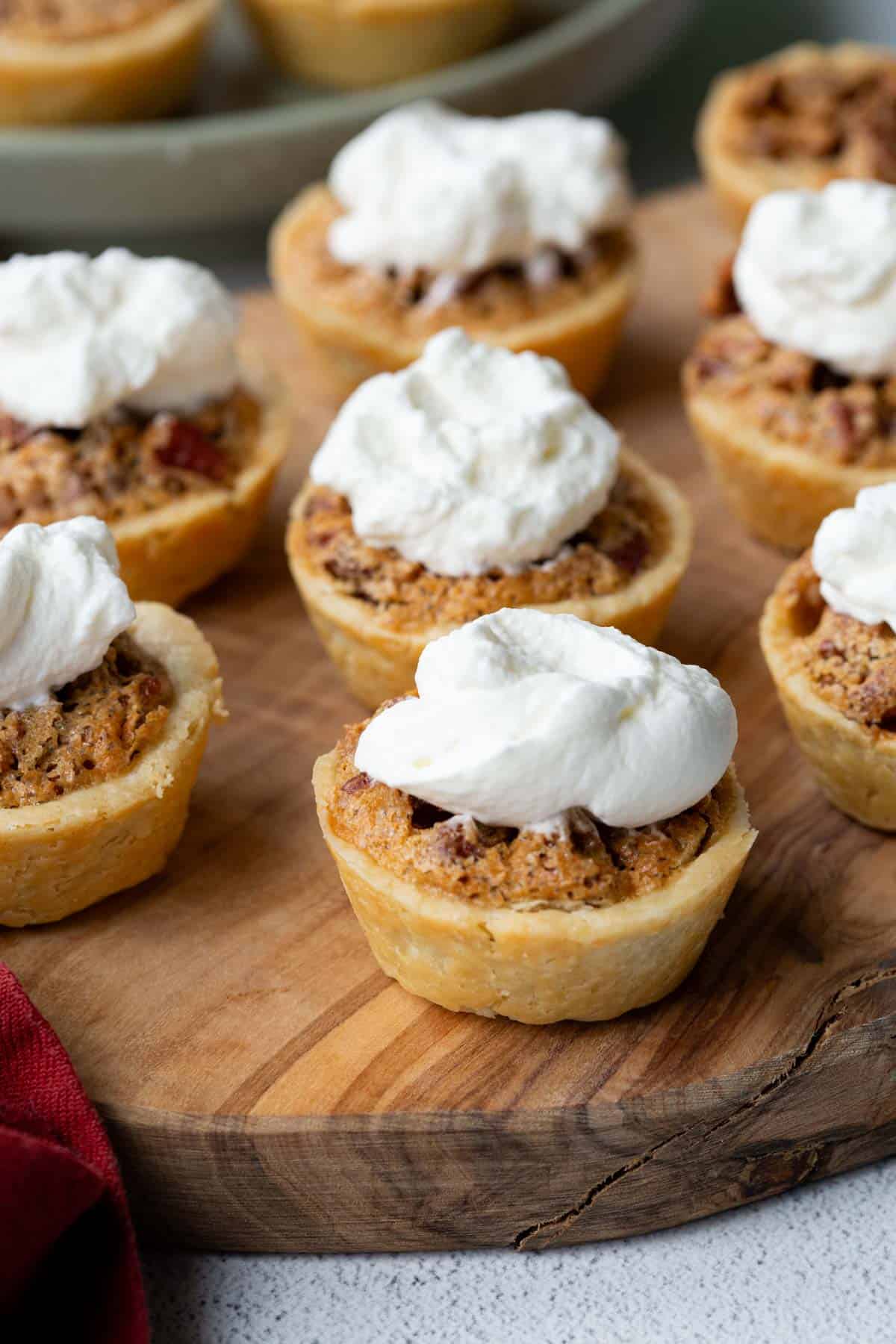 pecan tassies topped with whipped cream.