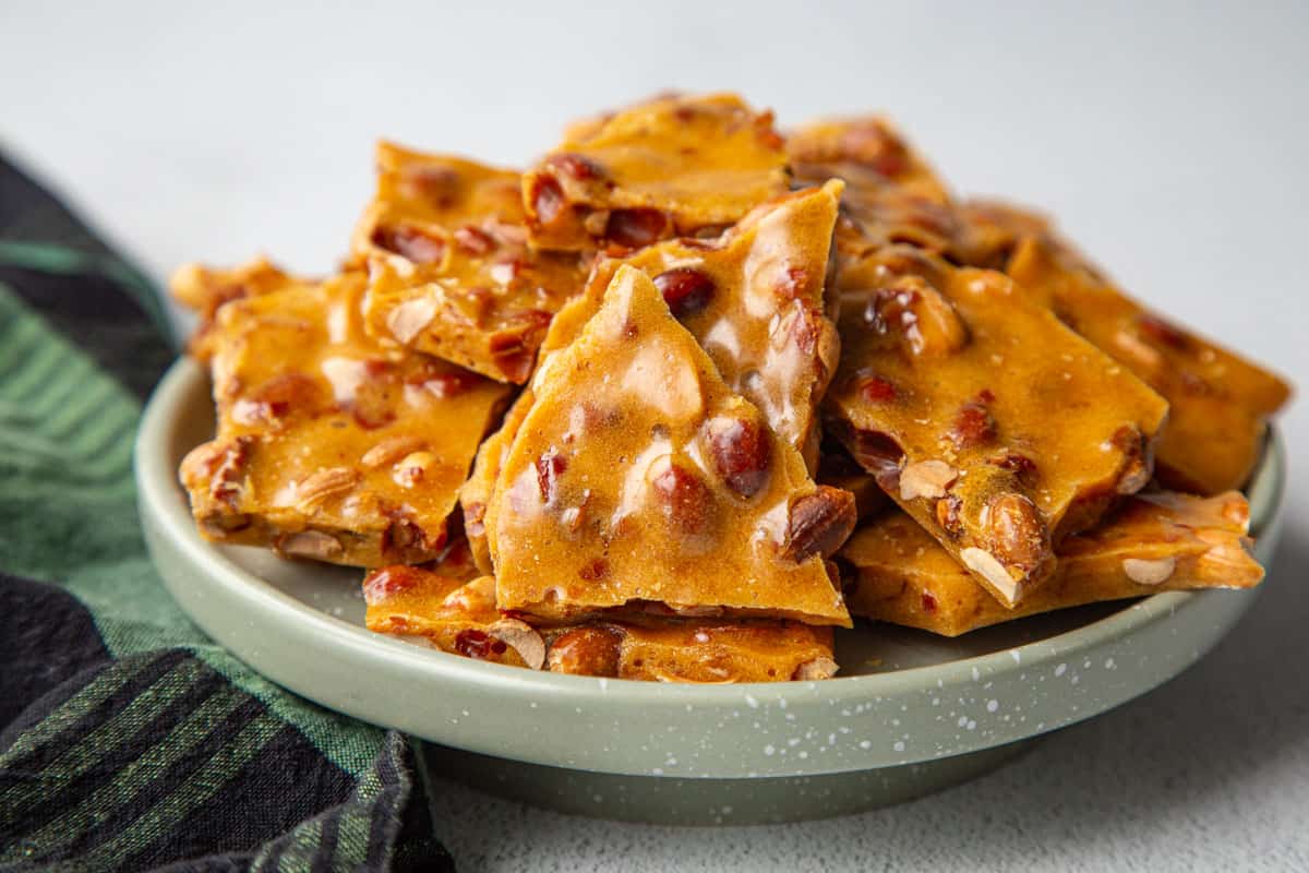 green pedestal platter topped with peanut brittle.
