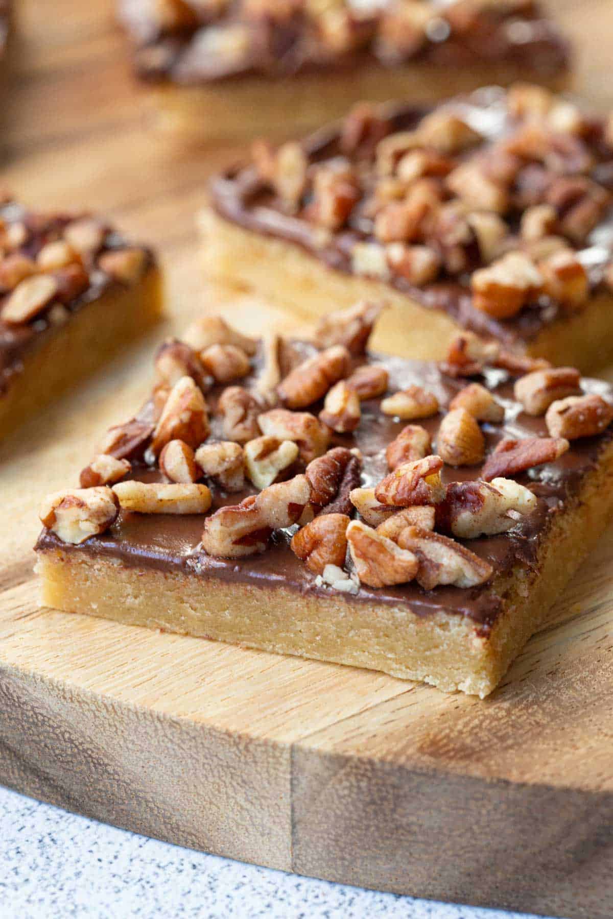 toffee squares on a wooden board.
