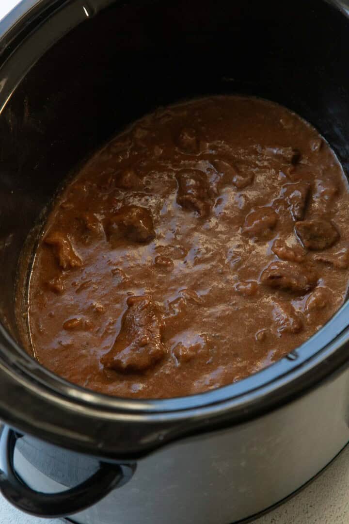 beef in a thick paprika sauce in a crockpot.