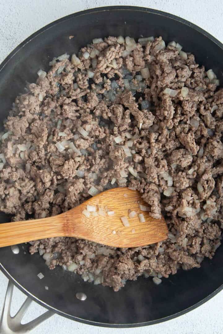 ground beef and onions in a skillet.