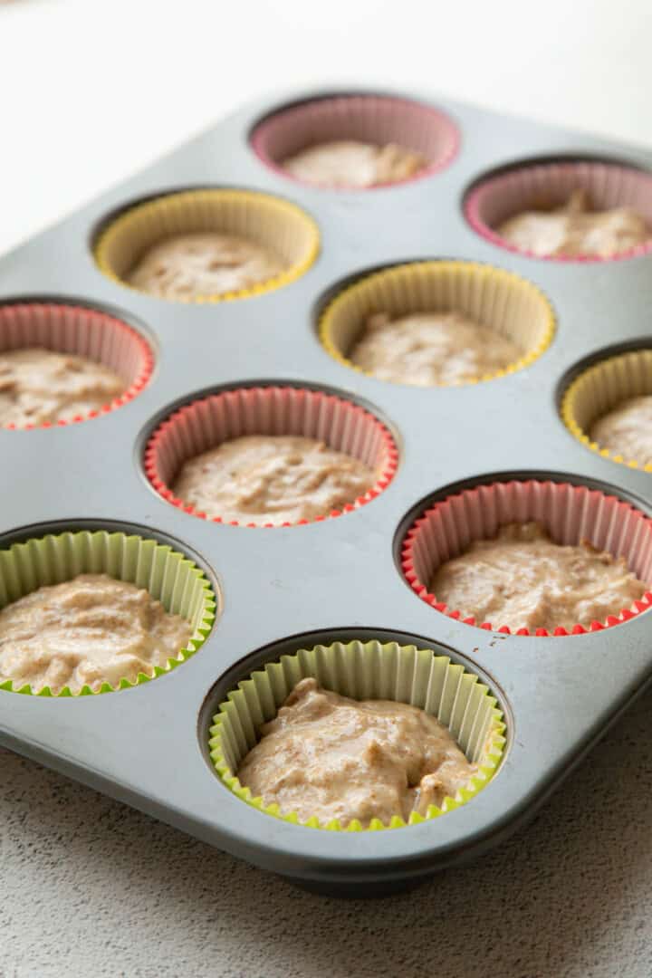 bran muffin batter in a muffin tin.