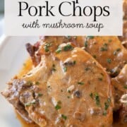 pork chops with mushroom soup sauce on a white platter.
