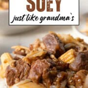 pieces of cubed beef and pork, with mixed canned vegetables, in a brown sauce over rice.