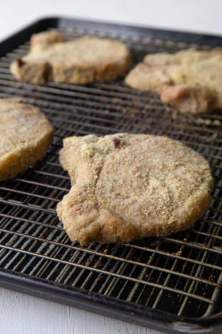 baked pork chops on a wire rack.