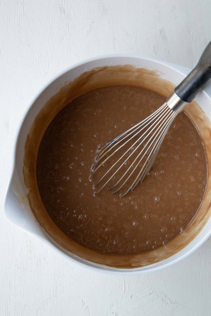 chocolate cake batter with a whisk.