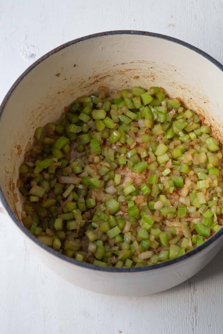chopped celery and onions in a pot.