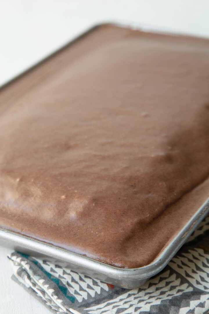 chocolate sheet cake with a shiny chocolate frosting.