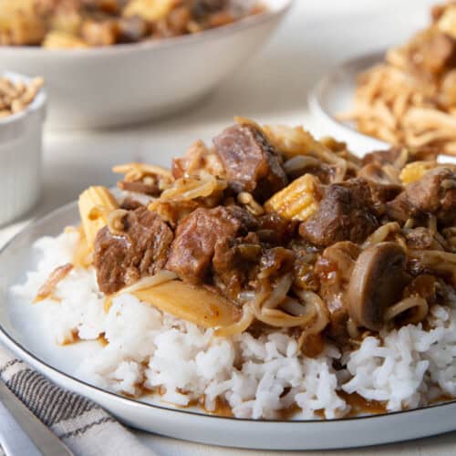 old fashioned chop suey on top of rice on a white plate.
