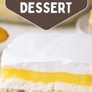 slice of lemon lush dessert with a shortbread crust, cream cheese layer, lemon pudding layer, and whipped topping layer.