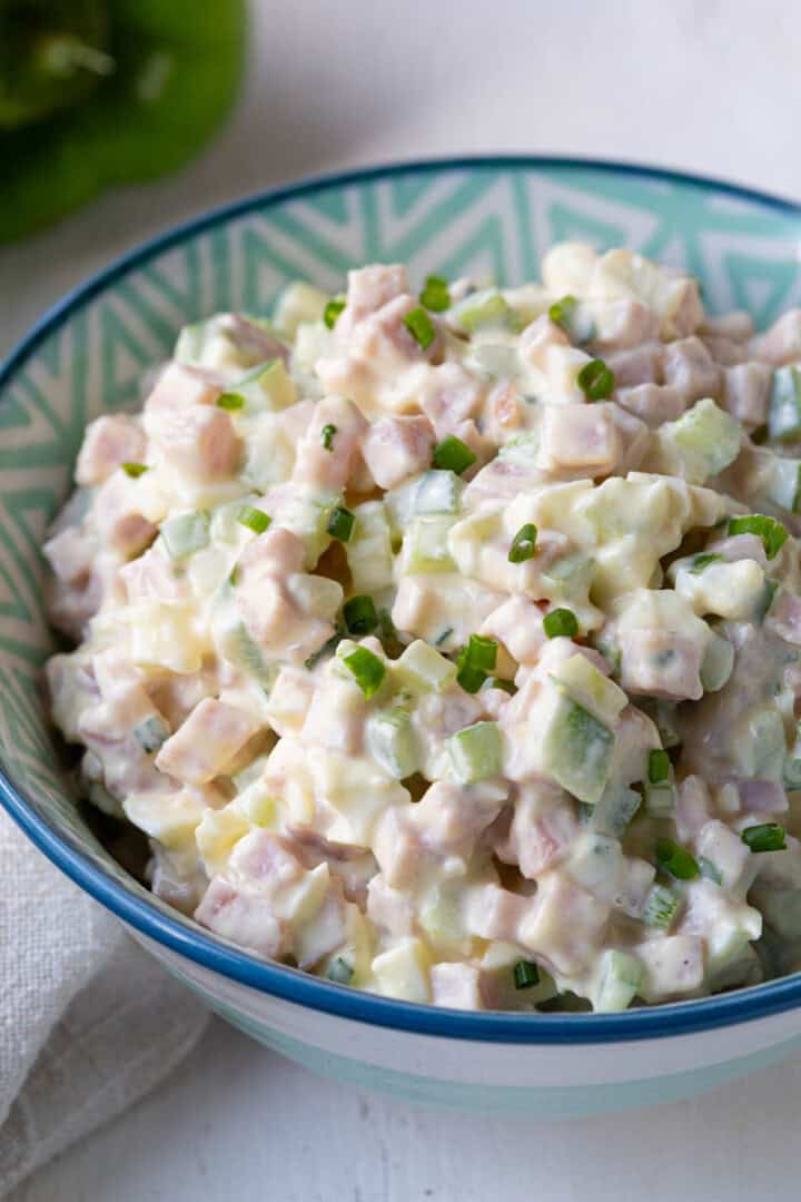bowl of ham salad topped with chives.