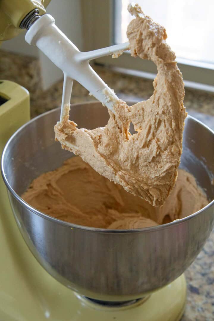 butter, sugar, and peanut butter mixed in a stand mixer.