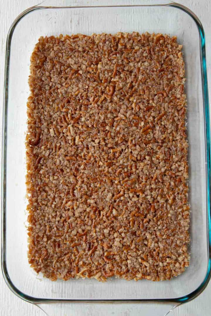 cooked pretzel crust in a baking dish.