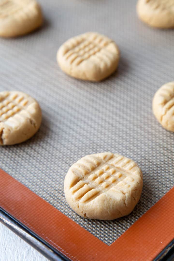 peanut butter cookie dough with criss cross marks from a fork.