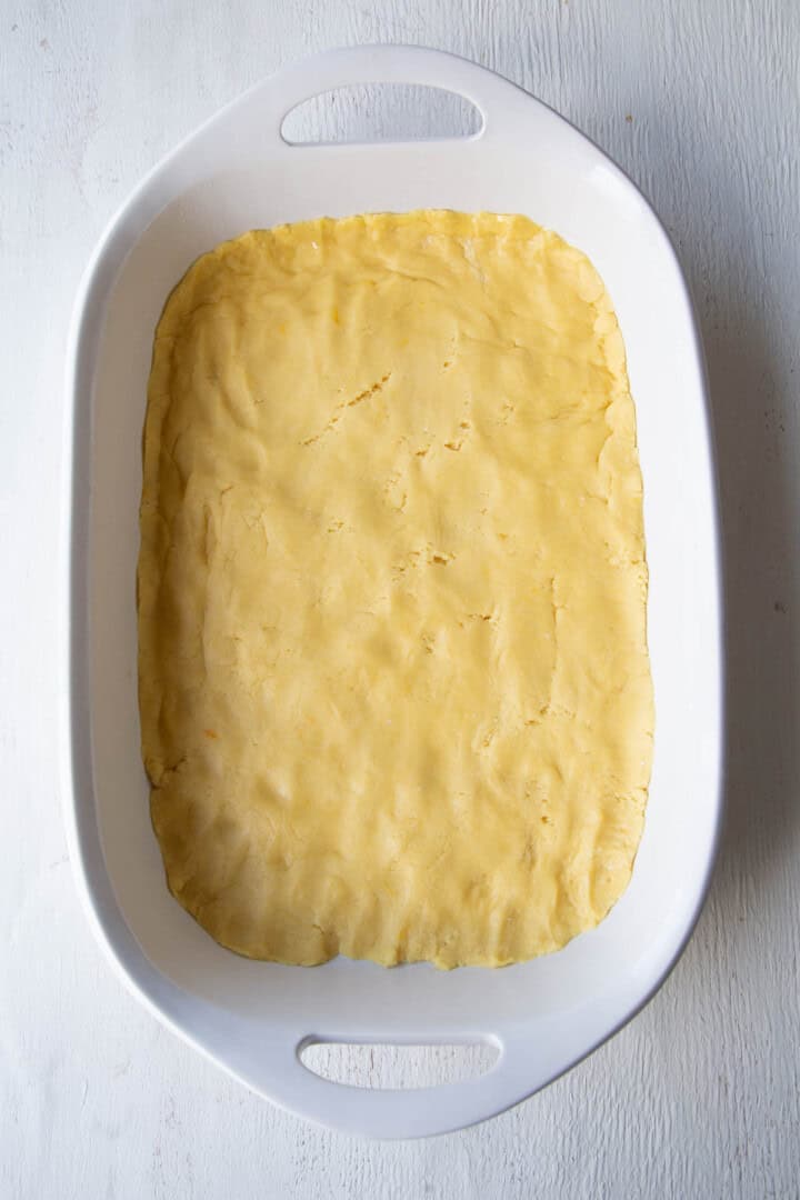 unbaked cake mix crusted in a white casserole dish.