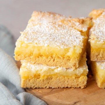 two slices of ooey gooey butter cake stacked on top of each other.