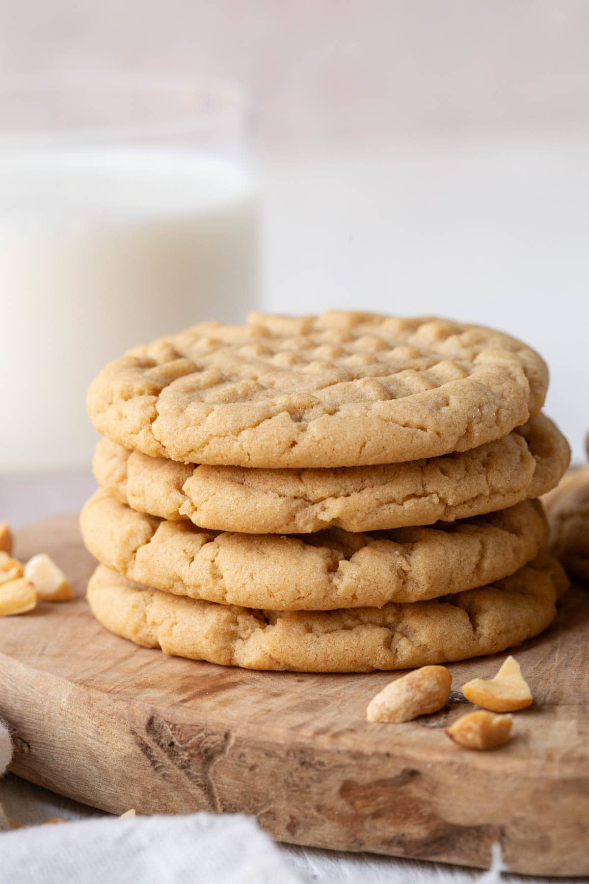 stack of peanut butter cookies with a glass of milk.