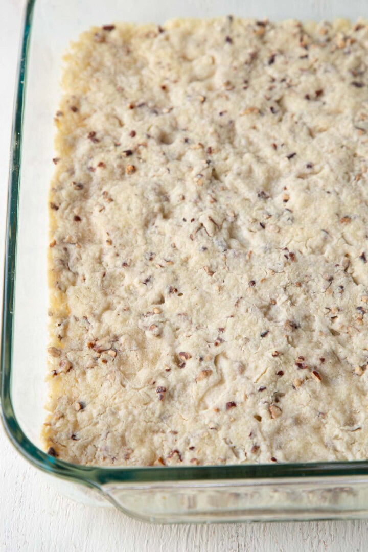 cooked pecan crust in a baking dish.