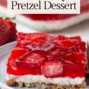 slice of strawberry dessert with a pretzel crust.