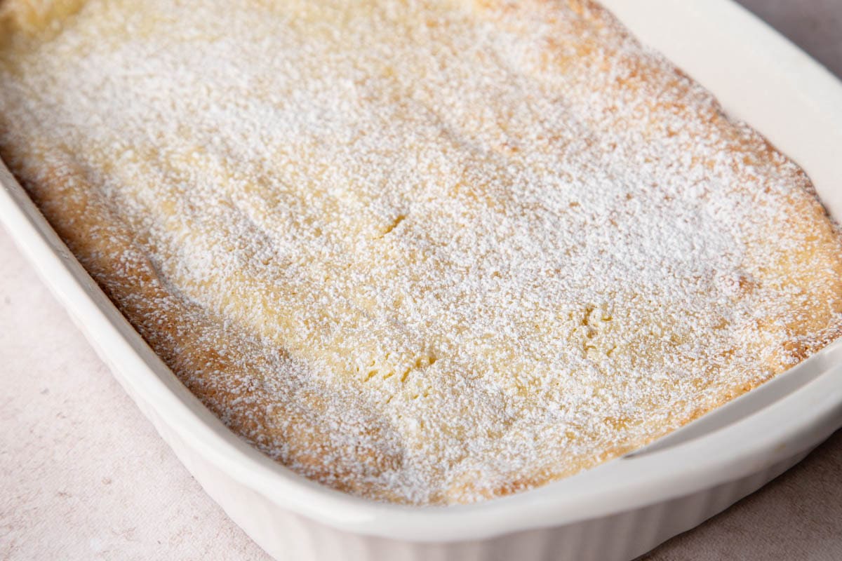 gooey butter cake topped with powdered sugar.