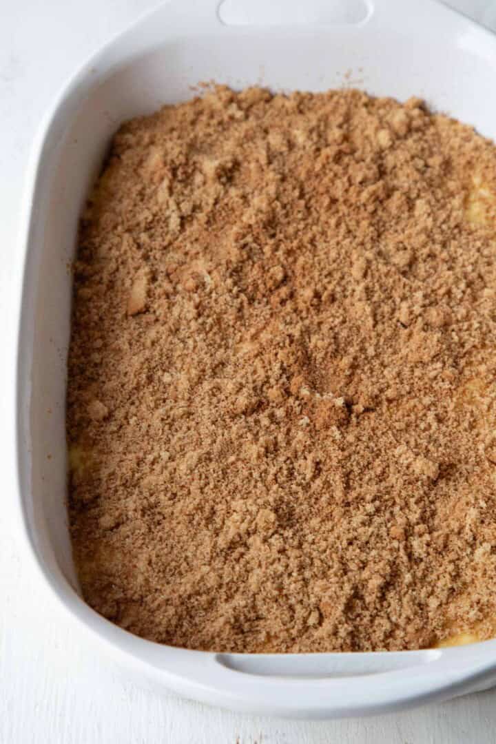 cinnamon and sugar on top of cake batter in a baking dish.