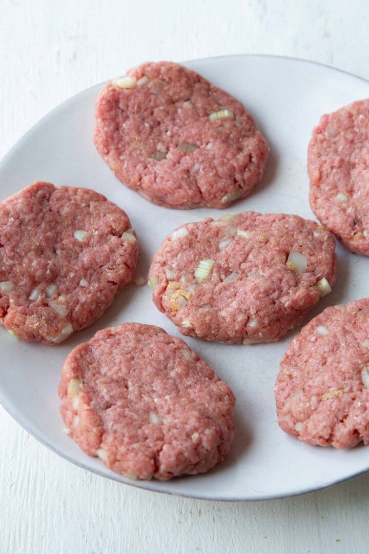raw meat shaped into oval patties.