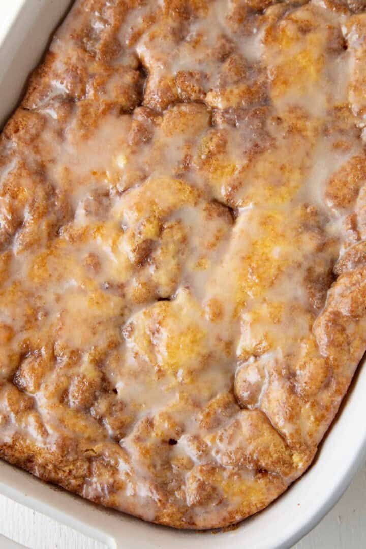 powdered sugar glazed topped honey bun cake.