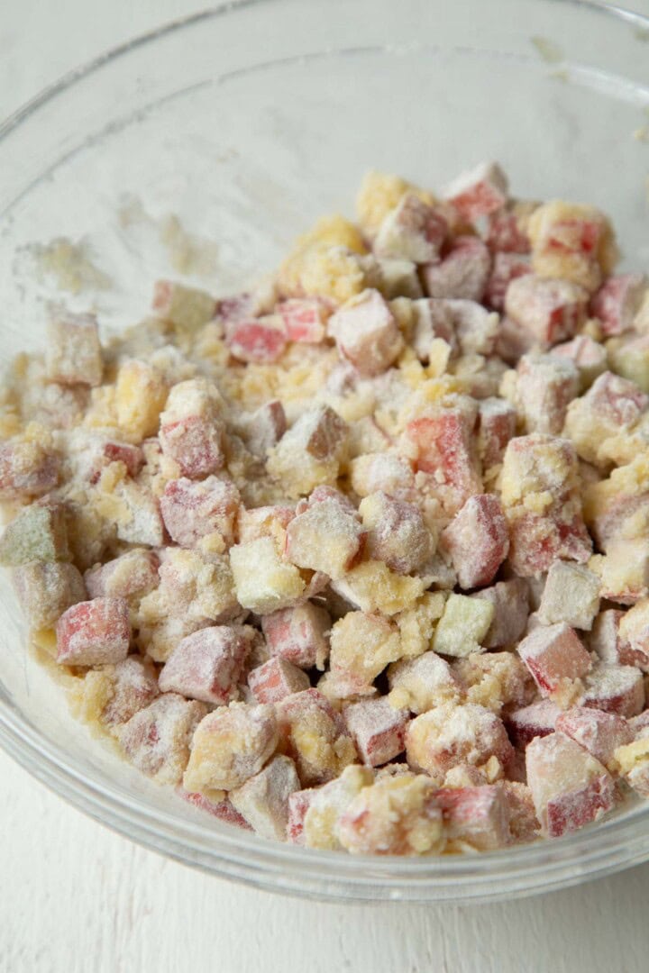sugar coated chopped rhubarb in a glass bowl.
