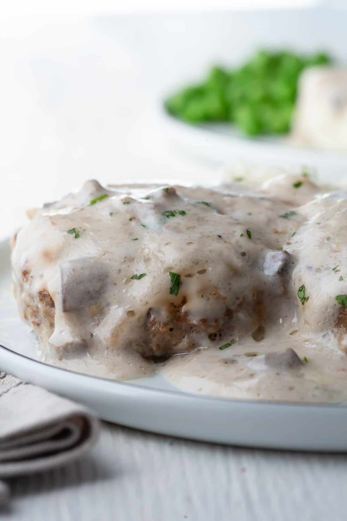 meat patty topped with cream of mushoom soup to create steak supreme.