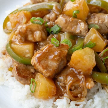 sweet and sour pork with pineapple on a bed of rice.
