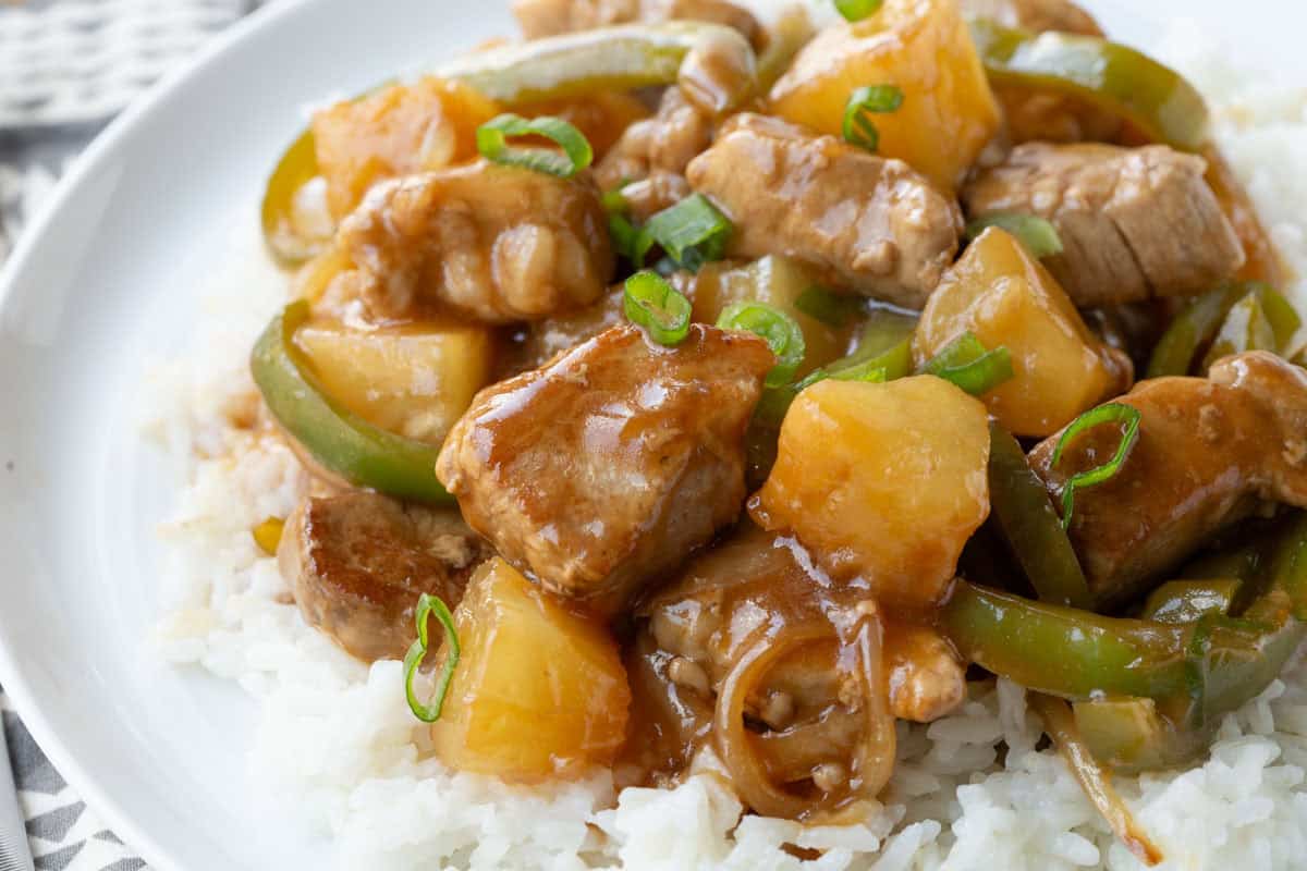 sweet and sour pork tenderloin on white rice.