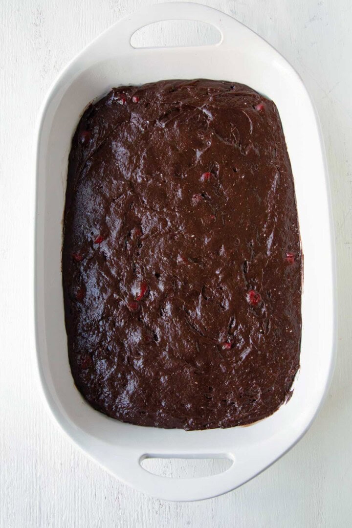 thick chocolate cherry cake batter in a pan.