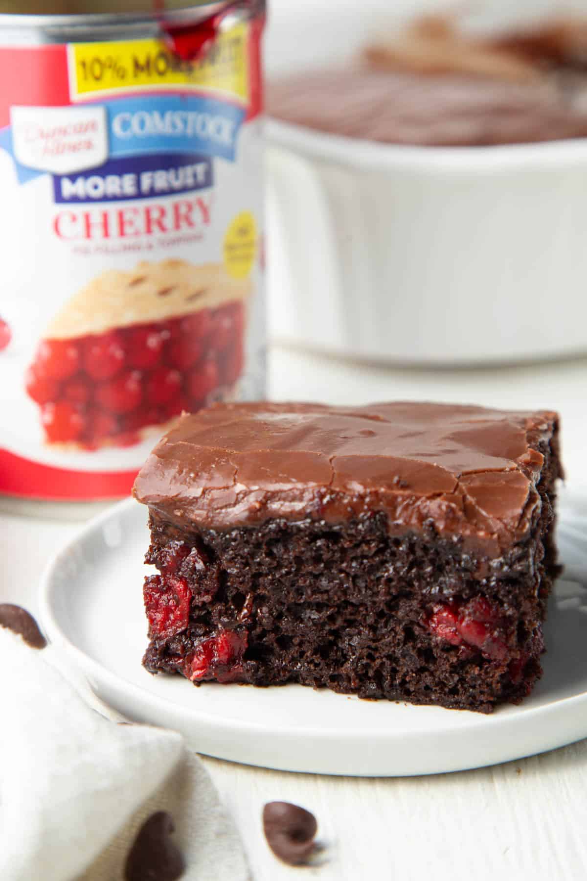 slice of chocolate cherry cake with a can of cherry pie filling. 