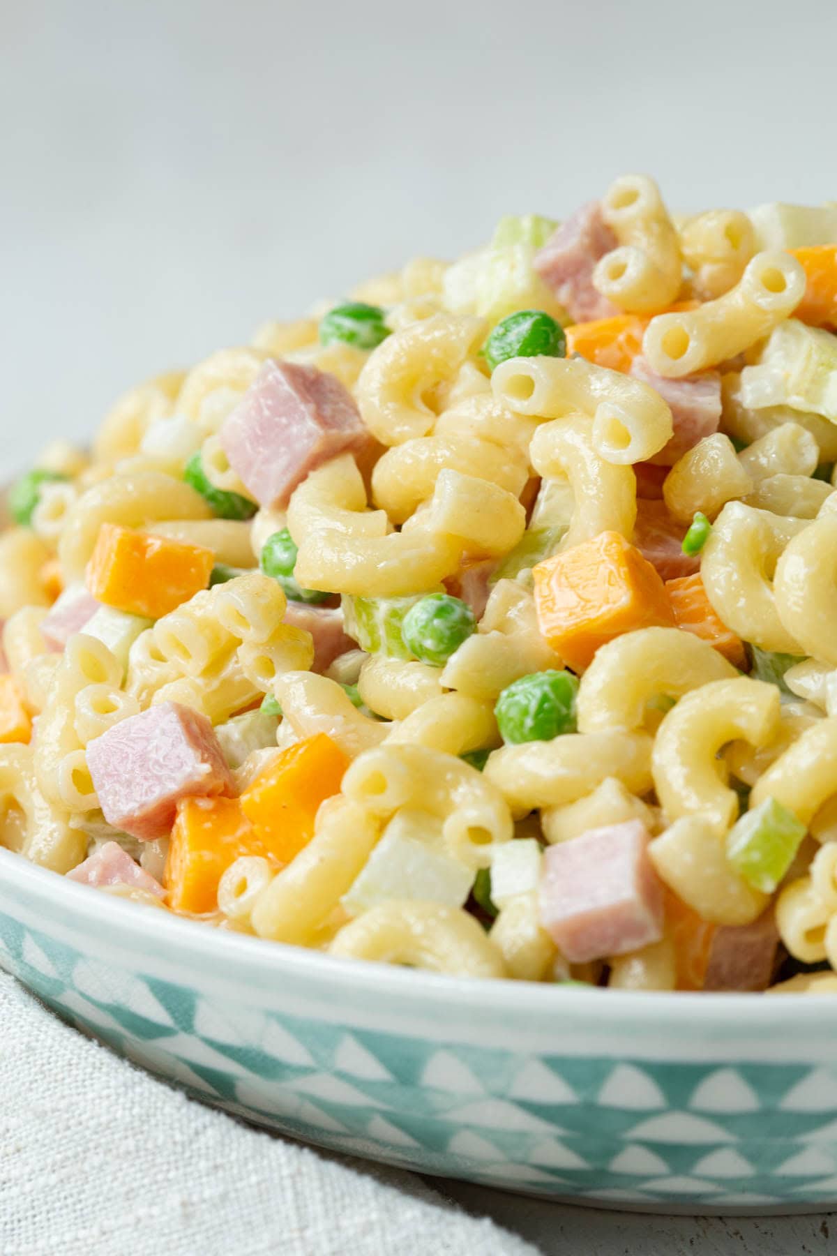 creamy macaroni salad with ham, peas, and cheddar cheese cubes.