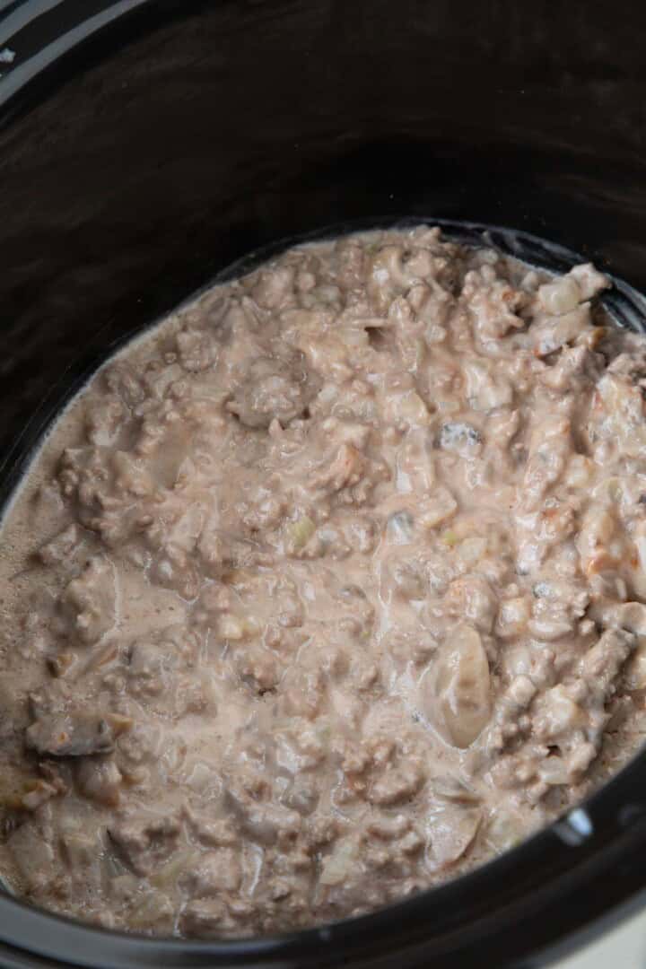 ground beef with cream of mushroom soup mixed in a crockpot.
