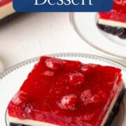 slice of layered gelatin dessert with blue, white, and red layers on a plate.