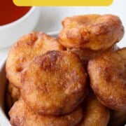 round corn fritters in a white bowl.