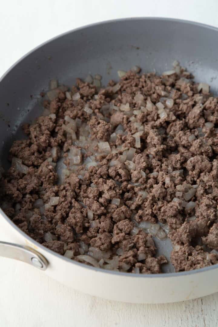 ground beef and onion in a skillet.