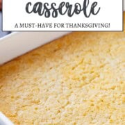 creamed corn casserole in a white casserole dish.