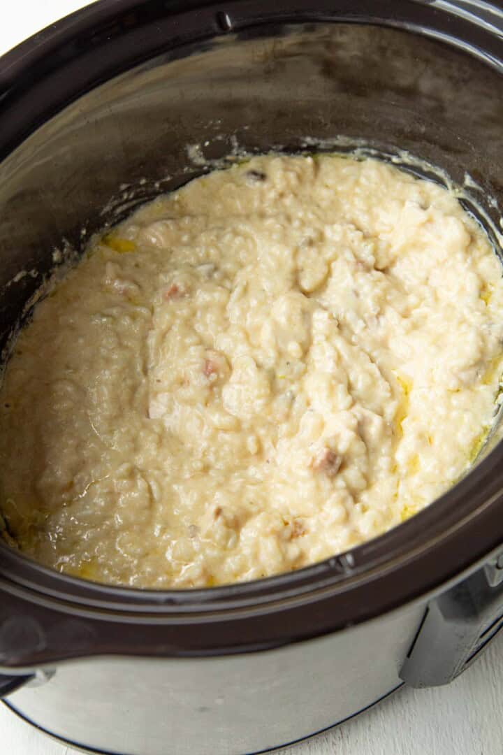 cooked chicken and rice in a creamy soup mixture in a crockpot.