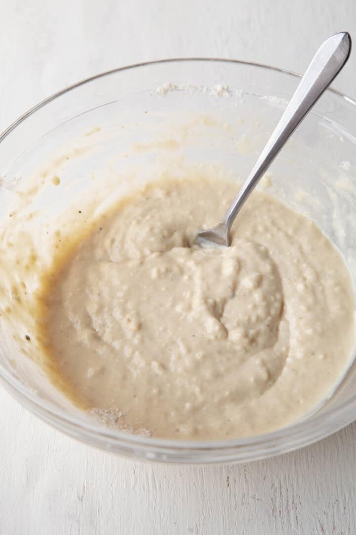 beige dumpling batter in a glass bowl.
