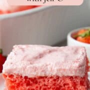 slice of strawberry cake with pink strawberry frosting.