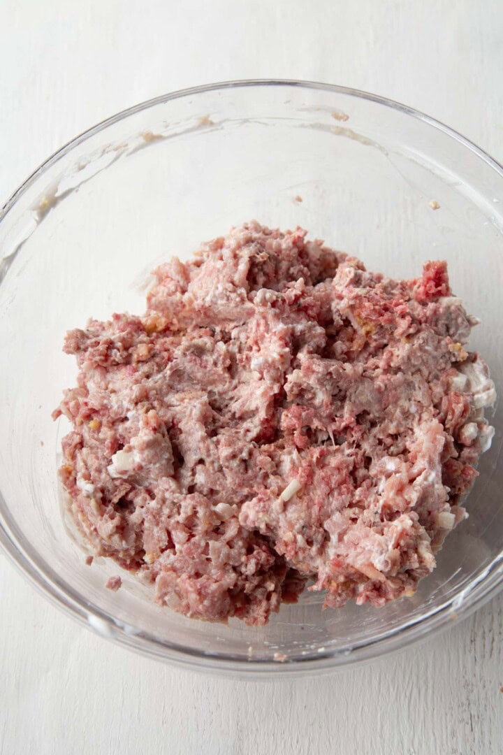 raw beef and sour cream mixture in a glass bowl.