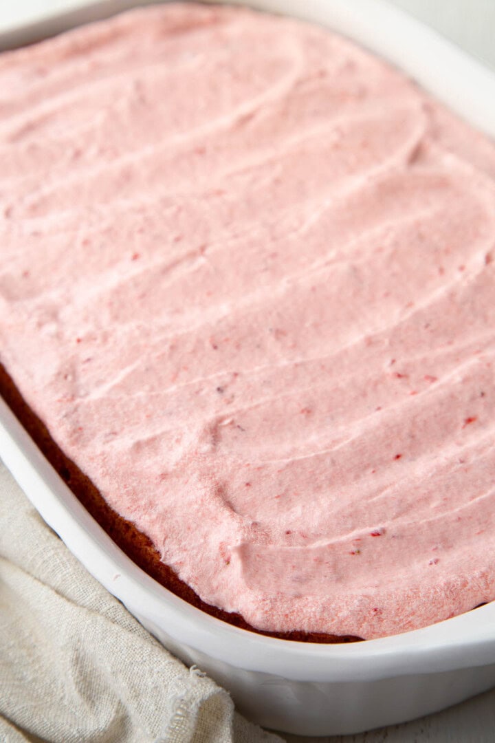 13x9-inch cake frosted with light pink strawberry frosting.