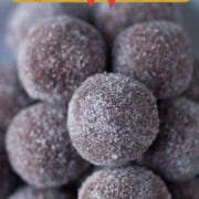 pile of chocolate rum balls coated in granulated sugar.