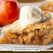 slice of double crust apple pie topped with vanilla ice cream.