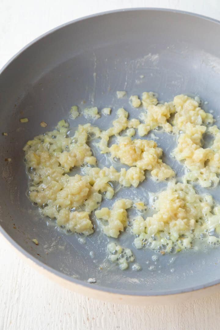 butter and onions cooking in a skillet with flour.